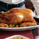 A beautiful, picturesque turkey on a platter hitting the Thanksgiving table